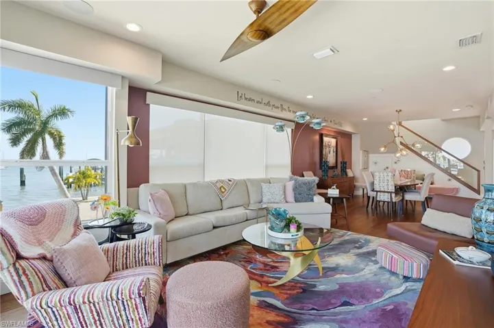 Living room with wood finished floors and recessed lighting - Virtually Edited Image