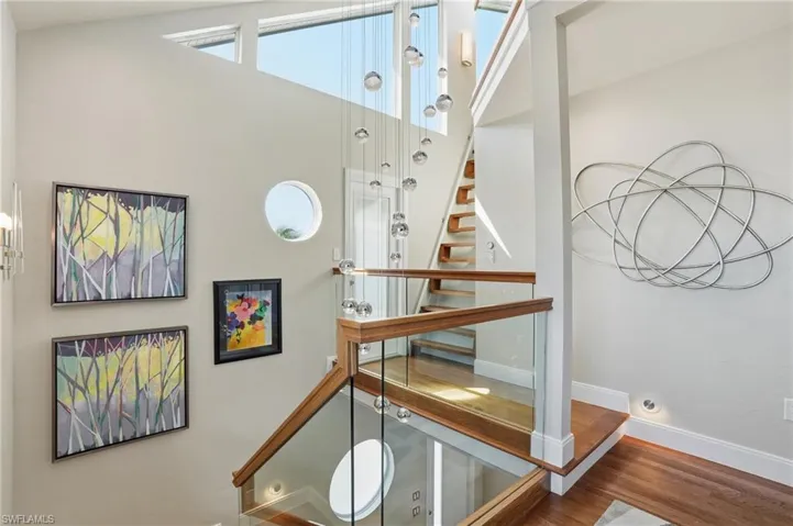Stairs featuring plenty of natural light and wood finished floors - Virtually Edited Image