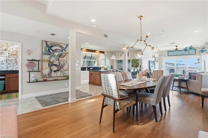 Dining space featuring ceiling fan, light wood finished floors, and recessed lighting - Virtually Edited Image