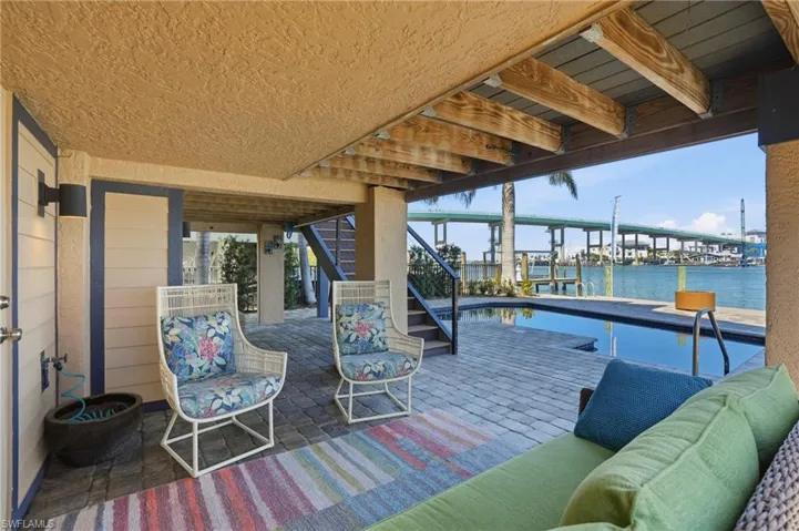 View of patio featuring a dock and a water view - Virtually Edited Image