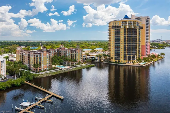 Water view featuring nearby urban area and a dock