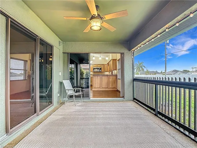Sunroom / solarium with a ceiling fan and a balcony