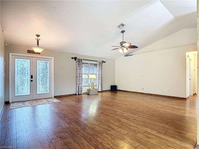 Entryway with french doors, hardwood / wood-style flooring, vaulted ceiling, and a ceiling fan