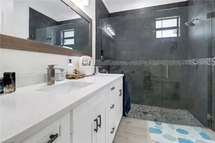 Bathroom featuring vanity and an enclosed shower