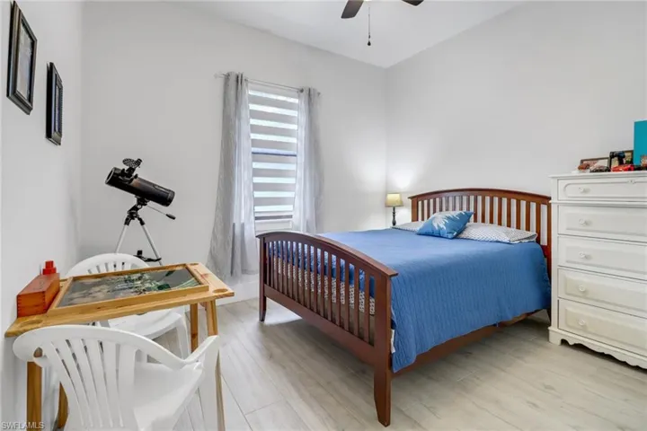 Bedroom with light hardwood / wood-style flooring and ceiling fan