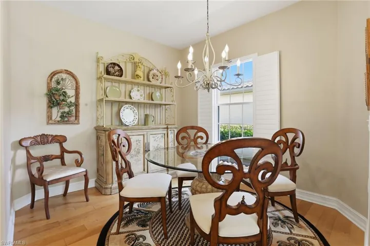 Dining room featuring suspended lighting and light wood-style flooring