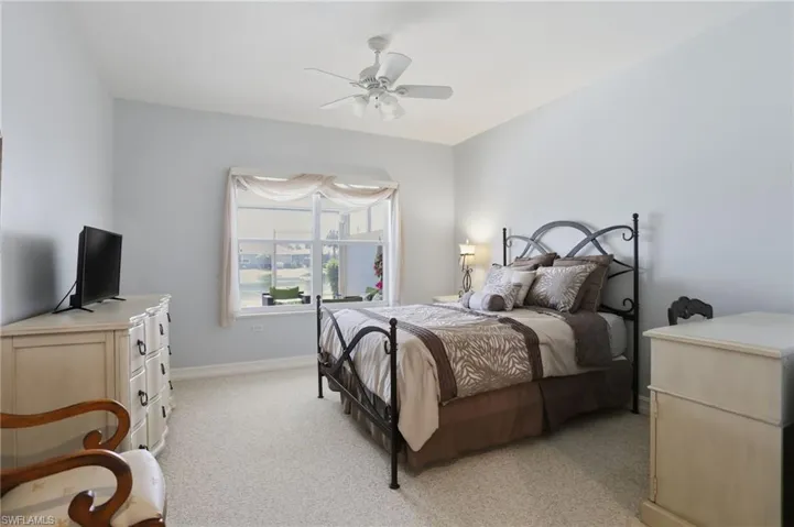 Bedroom featuring light carpet and a ceiling fan
