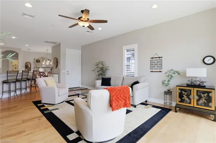 Living room featuring recessed lighting, light wood finished floors, and a ceiling fan