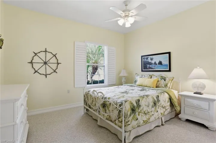 Bedroom with light carpet and ceiling fan