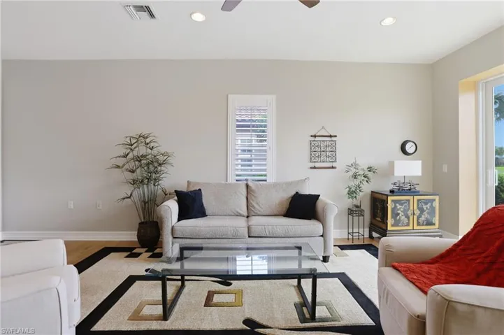 Living room featuring ceiling fan, recessed lighting, and wood finished floors