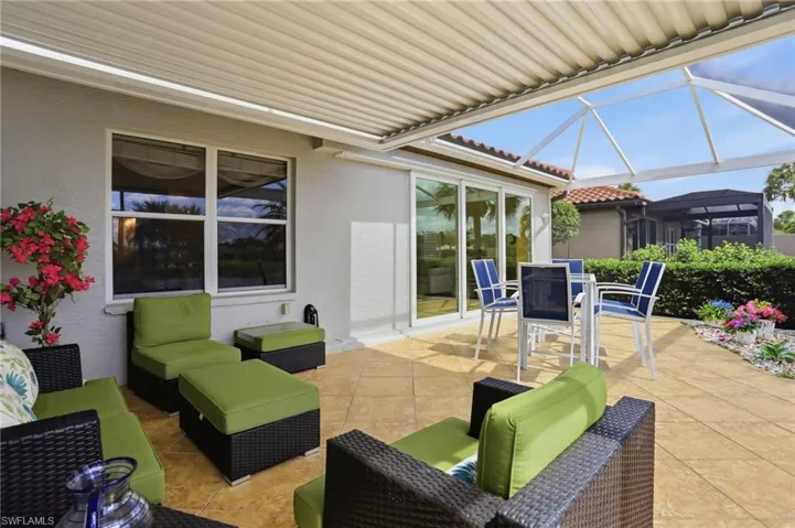 View of patio featuring glass enclosure, a sunroom, and outdoor lounge area