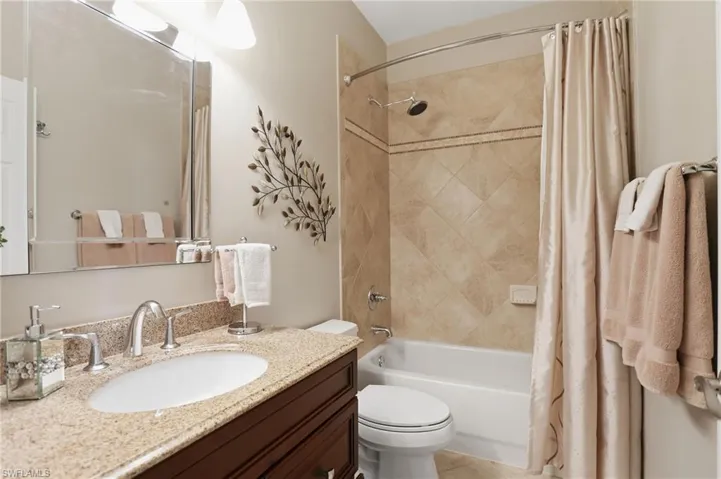 Bathroom with vanity and shower / bath combination with curtain