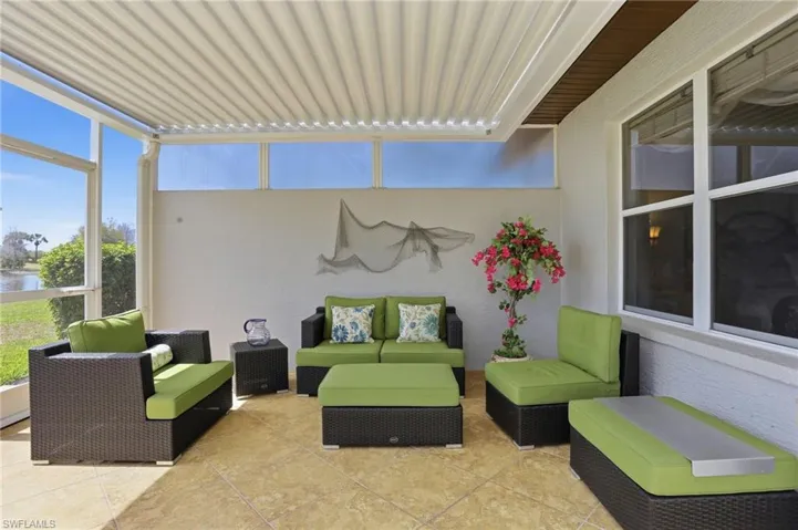 View of patio / terrace featuring an outdoor lounge area, a sunroom, and a water view