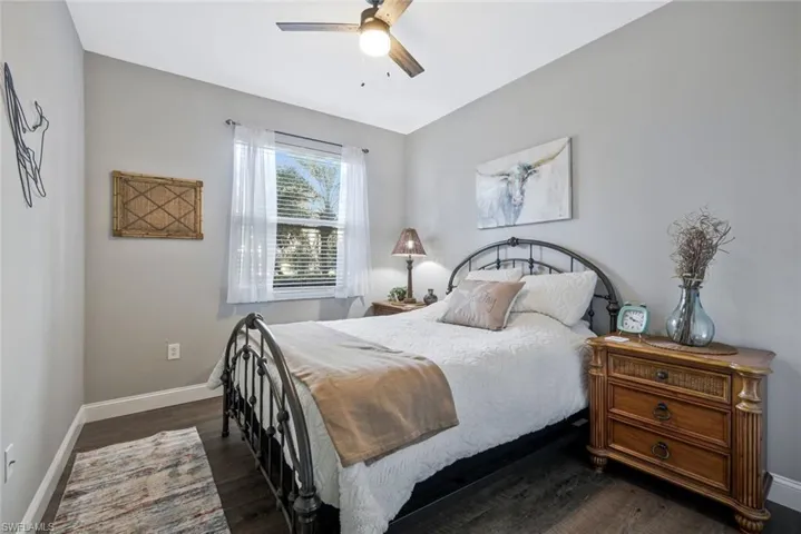 Bedroom featuring dark wood-type flooring and ceiling fan