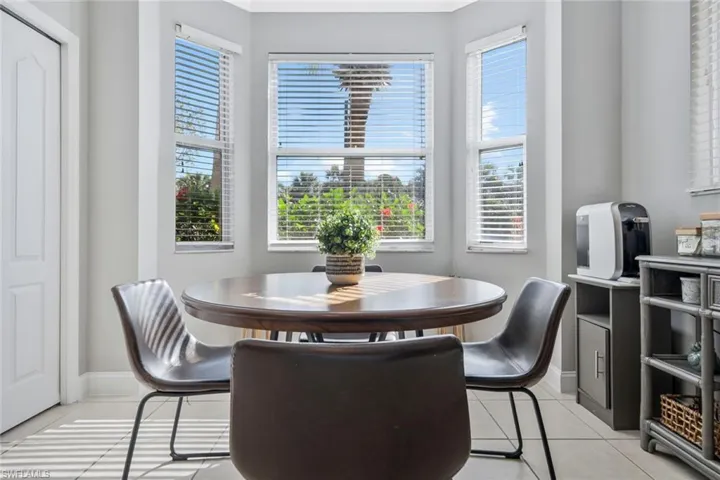 Dining area featuring light tile patterned floors and plenty of natural light