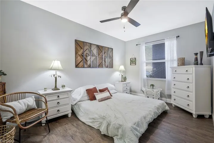 Bedroom with dark wood finished floors and a ceiling fan