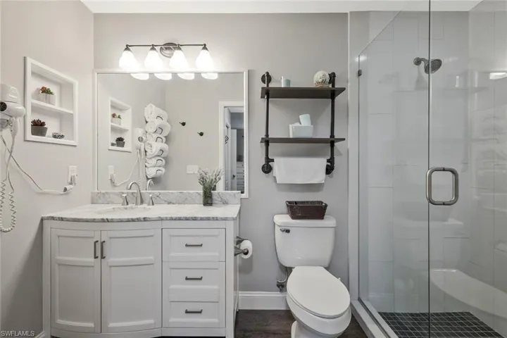 Bathroom featuring a shower stall and vanity