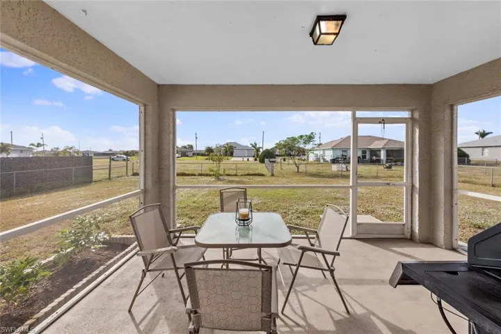 Sunroom / solarium featuring outdoor dining area and a residential view