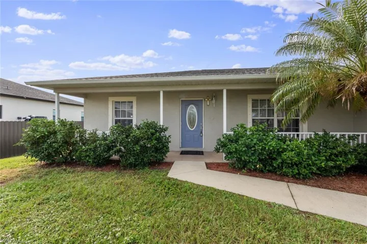 Ranch-style house featuring stucco siding and covered porch