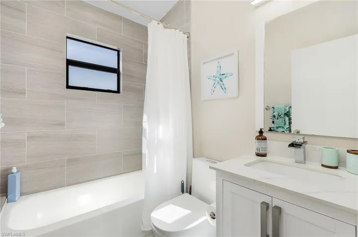 Bathroom featuring vanity, toilet, and shower / bath combo