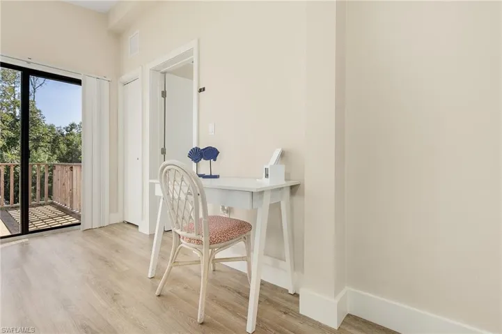 Home office with baseboards and light wood finished floors