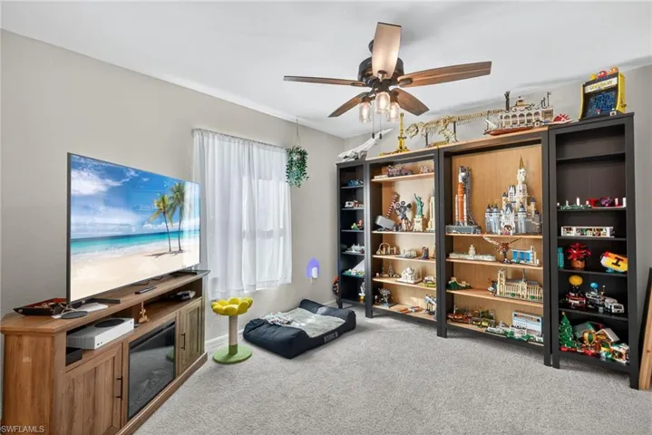 Playroom featuring light carpet and ceiling fan