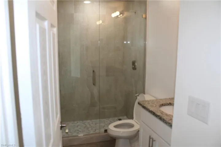 Bathroom featuring vanity and a stall shower