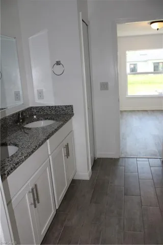 Bathroom featuring wood finished floors and double vanity