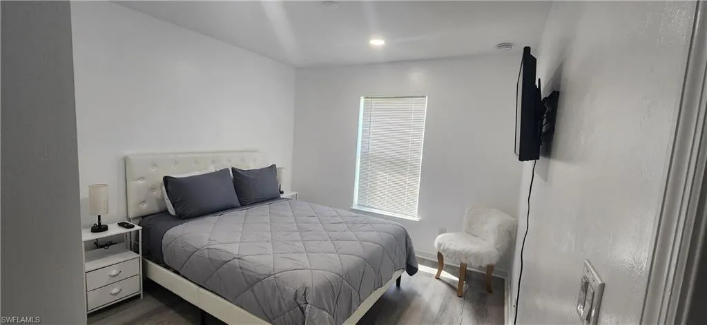 Bedroom featuring wood finished floors and baseboards