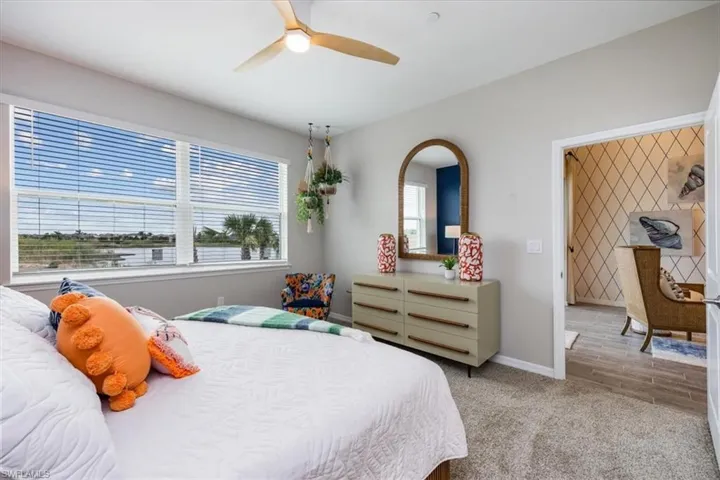 Bedroom with light carpet and ceiling fan