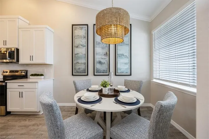 Dining room featuring crown molding and a notable chandelier