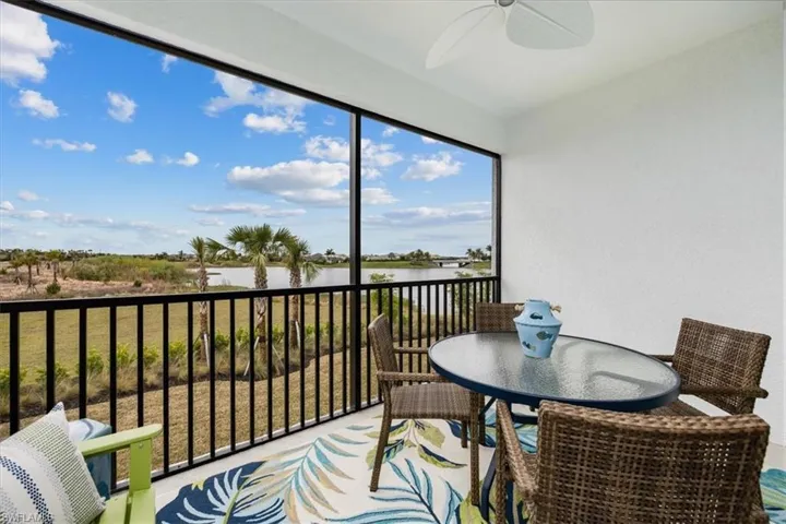 Sunroom featuring a water view and ceiling fan