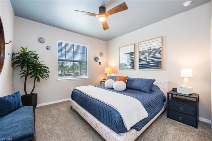 Bedroom with ceiling fan and carpet flooring