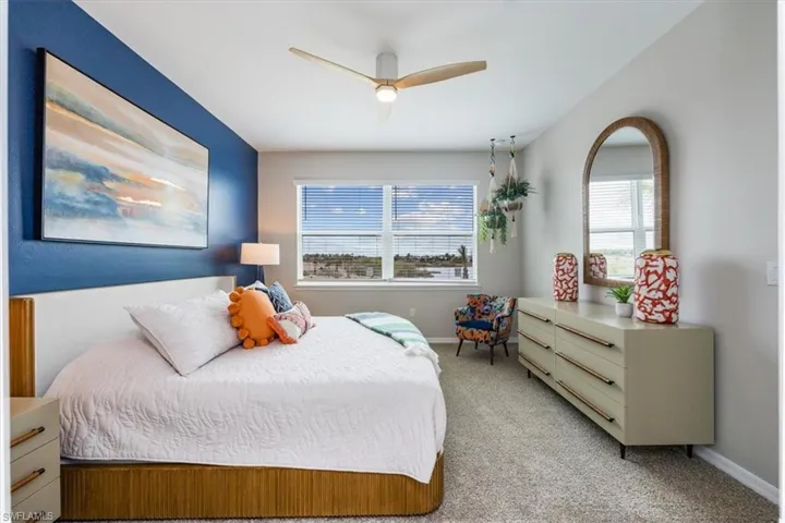 Bedroom featuring light carpet and ceiling fan