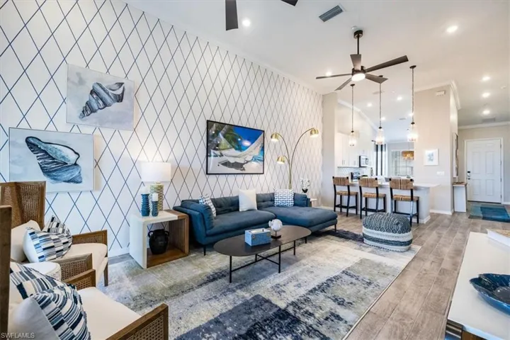 Living room featuring ornamental molding and ceiling fan