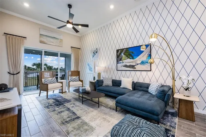 Living room with crown molding and ceiling fan