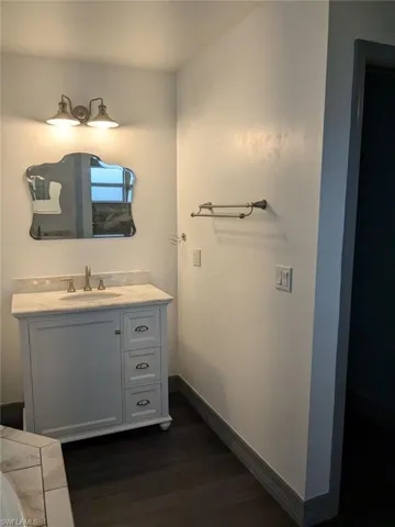 Bathroom featuring vanity and hardwood / wood-style floors