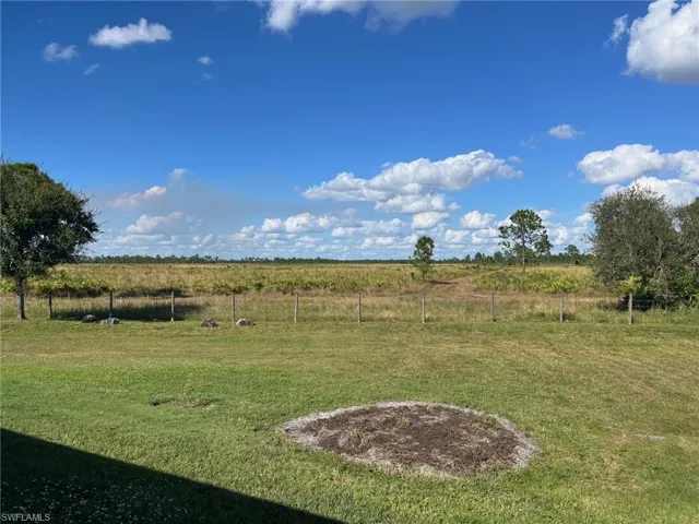 View of yard with a rural view