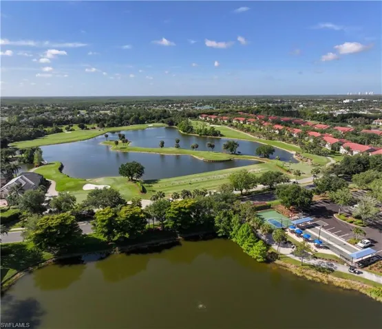 Aerial perspective of suburban area with a golf club and a large body of water