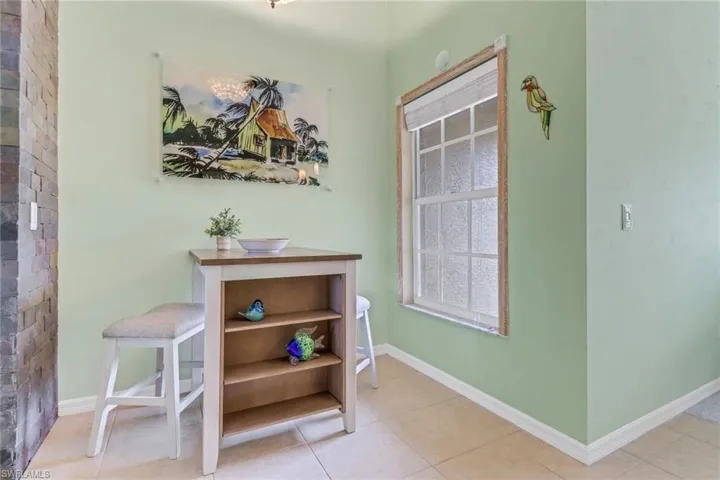 Entryway with baseboards and tile patterned floors