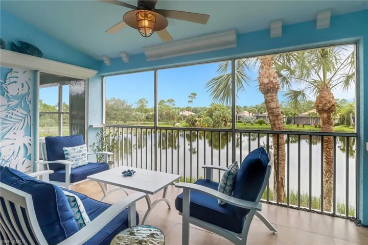 Sunroom / solarium featuring a water view