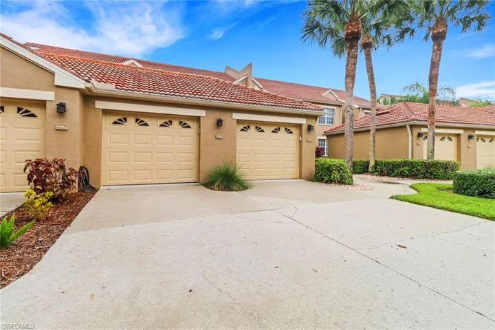 Mediterranean / spanish-style house featuring stucco siding, a tile roof, concrete driveway, and a garage