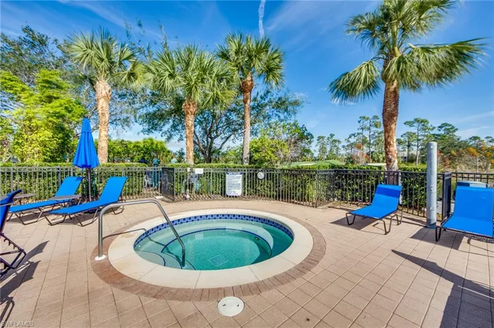 View of swimming pool featuring a hot tub, a patio, and a swimming pool