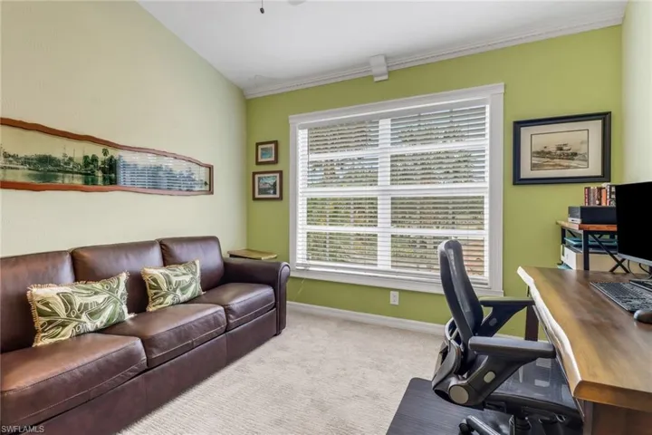 Carpeted home office with baseboards