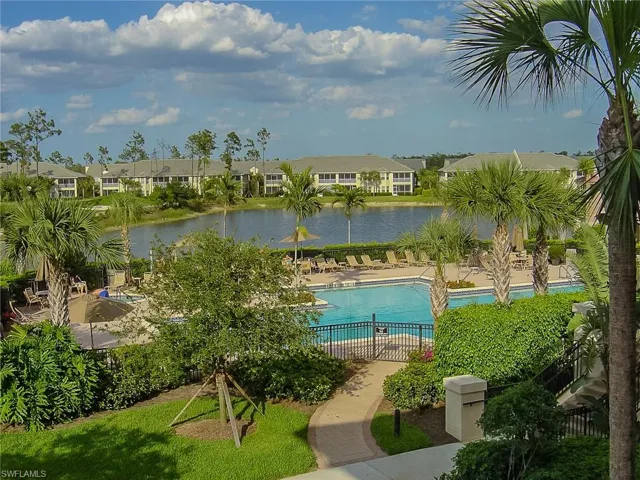 Community pool with a residential view, a water view, and a patio