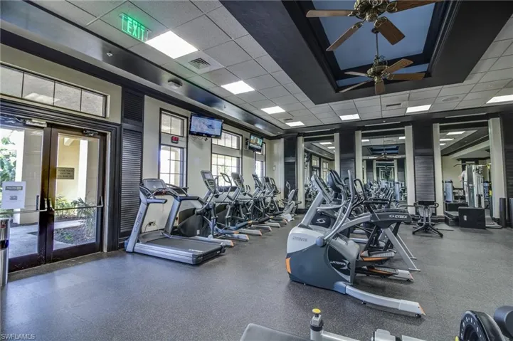 Gym featuring a paneled ceiling and ceiling fan