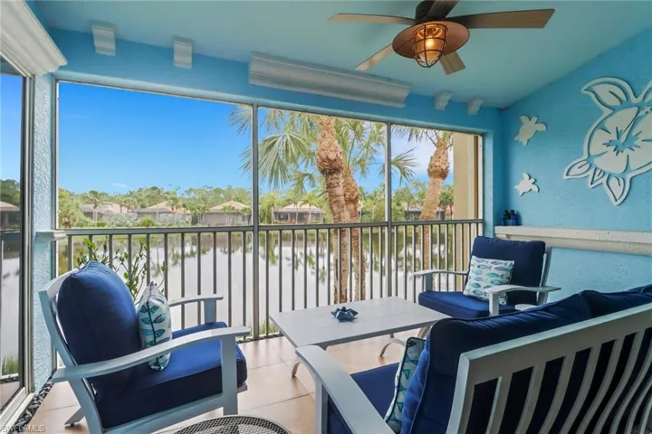 Sunroom / solarium featuring a water view