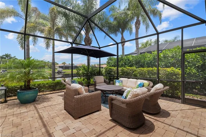 View of patio with outdoor seating, a sunroom, and a lanai