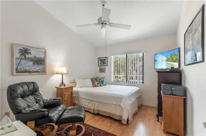 Bedroom featuring lofted ceiling, ceiling fan, and hardwood / wood-style floors