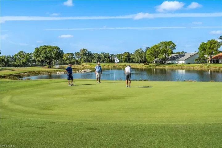 Surrounding community featuring a lawn and a water view